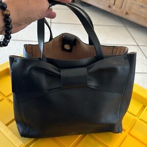 Black leather. no spots stains or scratches in excellent like new condition.